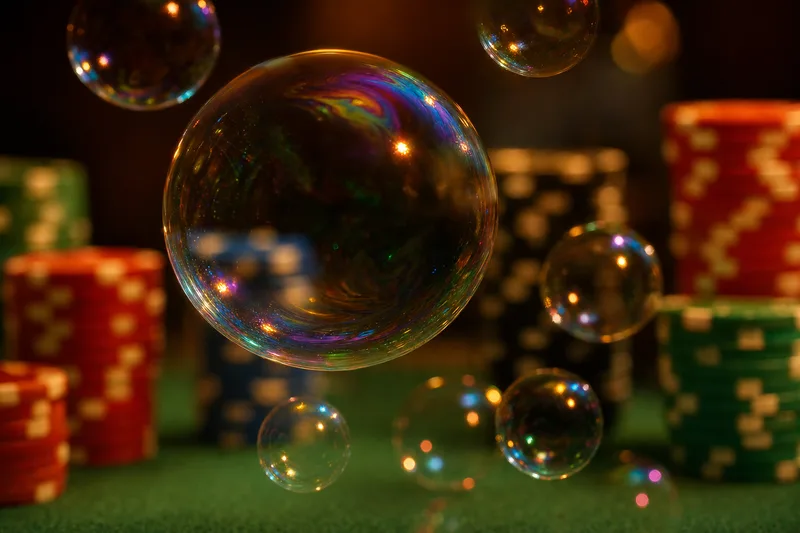 Soap bubbles floating above poker chips on a green felt table, symbolic of the money bubble